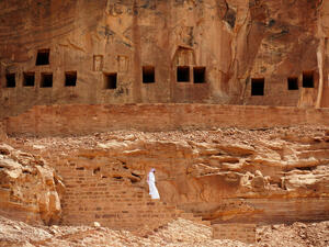 A Saudi man walking near ancient tombs at the Khuraiba archaeological site near Saudi Arabia’s northwestern town of al-Ula. (AFP)