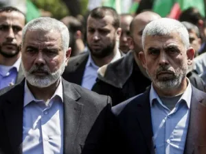 Yahya Sinwar (R) the new leader of Hamas in the Gaza Strip and senior Hamas official Ismail Haniyeh attend the funeral of Hamas official Mazen Faqha in Gaza. (AFP/File)