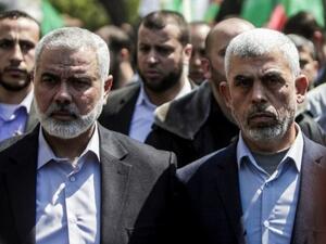 Yahya Sinwar (R) the new leader of Hamas in the Gaza Strip and senior Hamas official Ismail Haniyeh attend the funeral of Hamas official Mazen Faqha in Gaza. (AFP/File)