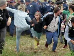 Hungarian TV camerawoman Petra Laszlo kicks a running child as refugees flee border police near the Serbian border with Hungary. (AFP/File)