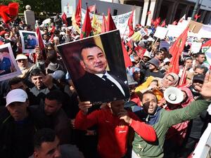 Moroccan protesters in the capital city of Rabat hold posters of their king, in opposition to Ban Ki-Moon's statements on the Western Sahara. (AFP/Fadel Senna)