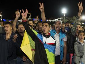 A protester carries the Amazigh (Berber) flag as protesters shout slogans in the northern city of Al Hoceima on October 30, 2016, following the death of fishmonger Mouhcine Fikri, who was crushed to death on October 28 in a rubbish truck. (AFP/Fadel Senna)