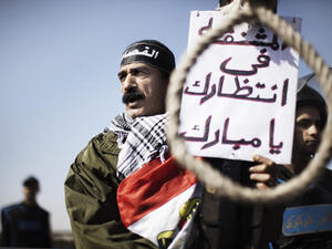 Protestors at Mubarak's sentencing in 2012. The sign reads, "this rope is waiting for you Mubarak." (AFP/File)