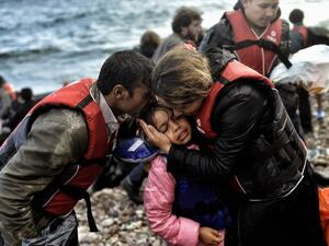 Syrian family becomes emotional after surviving the treacherous crossing between Turkey and Greece. (AFP/File)