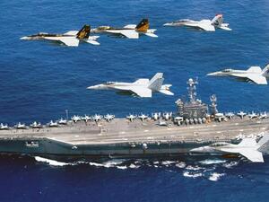 This photo released on June 19, 2016 by the US Navy shows a flight formation of Boeing F/A-18E and F Super Hornets above the aircraft carrier USS John C. Stennis in the Philippine Sea. (AFP/File)