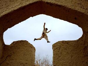 An Afghan boy plays in the ruins of a house that at one point belonged to the 13th-century Persian poet, Islamic scholar and Sufi mystic Jalal ad-Din Muhammad Rumi on the outskirts of Mazar-i-Sharif on November 25, 2015. (AFP/Farshad Usyan)