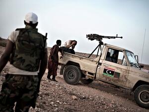 A Libyan rebel fighter waits nervously for the road to be cleared of mines near the front line. (AFP/Colin Summers) A Libyan rebel fighter waits nervously for the road to be cleared of mines near the front line. (AFP/Colin Summers)