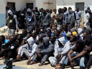 Refugees sit on the dock at the Tripoli port after being rescued by coast guard boats off the coast of Libya on June 7, 2016. (AFP/File)
