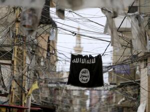 An ISIS flag hangs among electric wires over a street in Ain al-Hilweh Palestinian refugee camp, outside the port city of Sidon in southern Lebanon. (AFP/File)