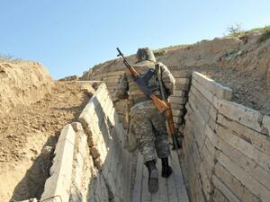 Armenian soldiers run in trenches at the frontline on the border with Azerbaijan, on October 25, 2012. (AFP/Karen Minasyan)
