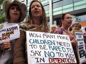 This image taken on February 4, 2016 shows human rights activists holding placards at a protest rally outside an immigration office in Sydney, Australia. (AFP/File)