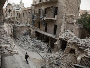 A Syrian man walks past destroyed buildings on May 2, 2016, in Aleppo. (AFP/File)