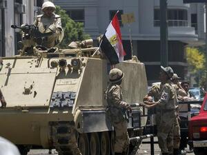Egyptian soldiers stand next to an armored personnel carrier on the road leading to Cairo University on July 4, 2013 in Cairo. (AFP/Gianluigi Guercia)