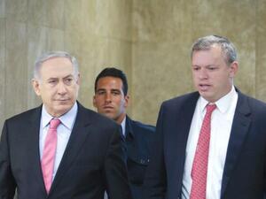PM Benjamin Netanyahu is accompanied by PMO Director-General Eli Groner to weekly cabinet meeting. (AFP/File)