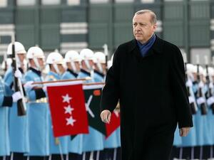 Turkish President Recep Tayyip Erdogan walks past an honor guard, in the capital, Ankara. (AFP/File)