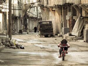 A Syrian girl rides her bicycle in an almost deserted street in the Teshrin neighborhood of the Qabun area in Damascus on 3 January 2013. (AFP/Omar Al-Khani) A Syrian girl rides her bicycle in an almost deserted street in the Teshrin neighborhood of the Qabun area in Damascus on 3 January 2013. (AFP/Omar Al-Khani)