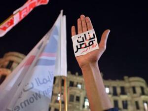 An Egyptian protester hold up his hand with a slogan reading in Arabic: “Egyptian girls are a red line” during a demonstration in Cairo against sexual harassment on 12 February 2013. (AFP/Khaled Desouki)