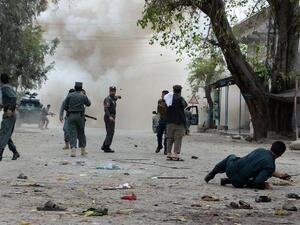 Security personnel look on after a second explosion following a suicide attack outside a bank in the eastern Afghan city of Jalalabad on April 18, 2015. (AFP/Noorullah Shirzada)