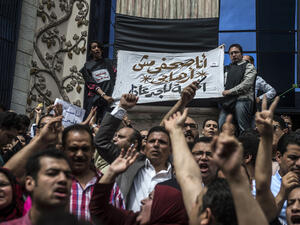 Journalists hold a banner reading in Arabic: "I am a journalist not a terrorist". (AFP/File)