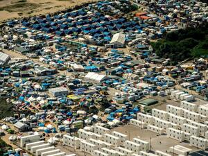 Migrants, including many children, have lived at the camp for the last 18 months. They will now be relocated. (AFP/File)