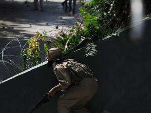 An Indian policeman prepares to fire a pellet gun towards Kashmiri protestors during clashes in Srinagar on July 29, 2016. (AFP/File)