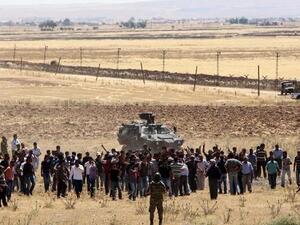 Turkish Kurds gather in Suruc in Sanliurfa province on the Turkish-Syrian border to show support for the people of the Syrian town of Kobane on Thursday. (AFP/File)