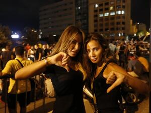 Lebanese protesters gesture during a demonstration organized by the "You Stink" campaign against the ongoing trash crisis in the capital Beirut on 22 August. (AFP/File)