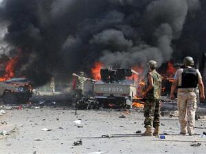Fighters from the pro-government forces loyal to Libya's Government of National Accord (GNA) look at some of their vehicles burning after a Daesh bomber detonated his explosives close to a group of soldiers in an area of central Sirte on August 16, 2016. (AFP/File)