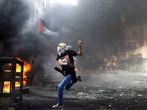 A masked Palestinian hurls rocks towards Israeli soldiers during clashes following the funeral of Mohammed Fares al-Jaabari on Oct. 10, 2015, in the center of the West Bank town of Hebron. (AFP/Hazem Bader) A masked Palestinian hurls rocks towards Israeli soldiers during clashes following the funeral of Mohammed Fares al-Jaabari on Oct. 10, 2015, in the center of the West Bank town of Hebron. (AFP/Hazem Bader)