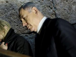 Benjamin and Sara Netanyahu leave after praying at the Westen Wall Tunnel in Jerusalem. (AFP/File)