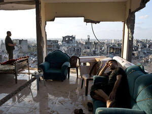 Palestinians from Gaza sit amidst the aftermath and rubble of Israeli airstrikes. (AFP/Roberto Schmidt)