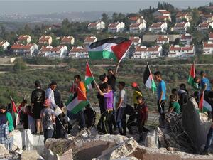 Palestinians from the West Bank protest near the Jewish Hallamish settlement. (AFP/File)