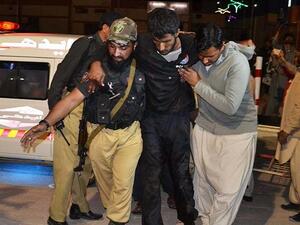A volunteer and a police officer rush an injured person to a hospital in Quetta. (AFP/File)