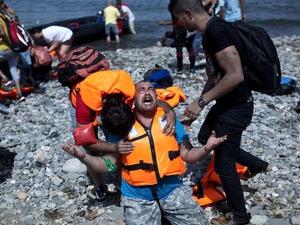 A refugee from Syria prays after arriving on the shores of the Greek island of Lesbos aboard an inflatable dinghy from Turkey. (AFP/File)