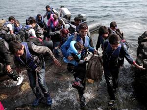 Syrian refugees land on the shores of the Greek island of Lesbos in an inflatable dingy across the Aegean Sea from Turkey, September 3, 2015. (AFP/Angelos Tzortzinis) Syrian refugees land on the shores of the Greek island of Lesbos in an inflatable dingy across the Aegean Sea from Turkey, September 3, 2015. (AFP/Angelos Tzortzinis)