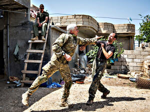 A 67-year-old man from Canada and a 40-year-old from the UK, nick-named by Kurdish fighters as Hewal Zinar and Hewal Cudi, train on the outskirts of the north-western Syrian town of Tal Tamr, north of Hasakeh, near the border with Turkey, as they fight alongside People Protection Unit (YPG) fighters under the commanders, Sider and Gerzan. (AFP/Uygar Onder Simsek)