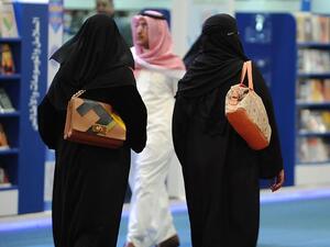 Fully veiled Saudi women browse the annual International Book Exhibition in the capital Riyadh on March 2016. (AFP/File)