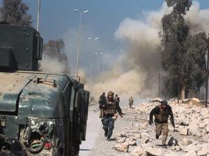 Smoke billows in the background as Iraqi forces advance on Mosul airport during an offensive. (AFP/File)