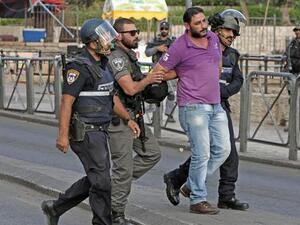 Israeli policemen detain a Palestinian, at the site where two Israeli police officers were stabbed. (AFP/File)