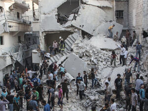 People gather around the destruction left after air strikes in Syria. (Twitter)