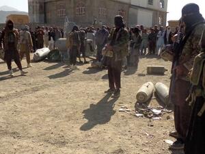 Afghan Taliban militants gather around parts of a US F-16 aircraft that was struck over in eastern Afghanistan. (AFP/File)