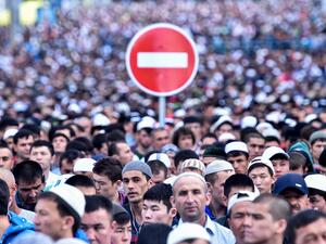 A traffic sign is seen behind Russian Muslims praying outside the central mosque in Moscow on Tuesday, during celebrations of Eid al-Fitr marking the end of the fasting month of Ramadan. (AFP/File)