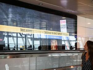 Passenger reads a billboard that reads, 'Travel warning - Do you know that Sweden has the highest rape rate worldwide? (AFP/Fulya Ozerkan)