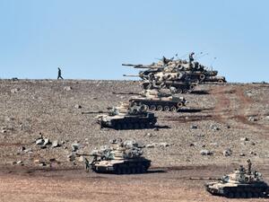 Turkish tanks line up on a hill near the border with Syria as Daesh jihadists besieged Kobane in 2014. (AFP/Aris Messinis)