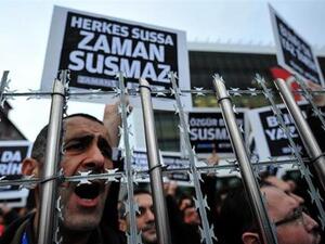 Staff members and supporters of Zaman newspaper shout slogans and hold placards reading 'Free press'. (AFP/File)
