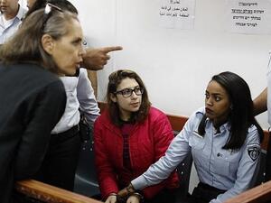 Nour Tamimi (C) who is being detained after a viral video showing her with two members of her family allegedly assaulting two Israeli soldiers is seen in a military court at the Ofer prison in the West Bank on December 28, 2017. (Ahmad Gharabli/AFP)