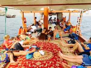 Tourists on a dhow boat in the Strait of Hormuz, Musandam, Oman. (Shutterstock/Imran's Photography)