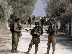 Israeli soldiers stand near the house of one Palestinian (AFP/File Photo)	