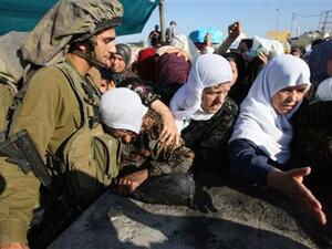 فلسطينيات ينتظرن على حاجز قلنديا في انتظار السماح لهن العبور للصلاة في الاقصى، الجمة/أ.ف.ب