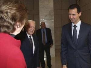 الاسد مستقبلا وفد مجموعة الحكماء